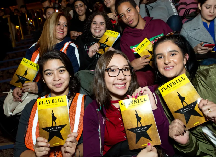 Students in the audience holding playbills